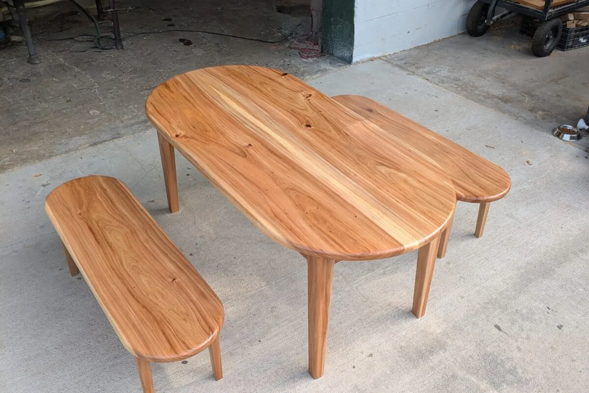 Custom wood coffee table with matching side tables featuring rounded organic edges and natural grain patterns in a warm honey tone.