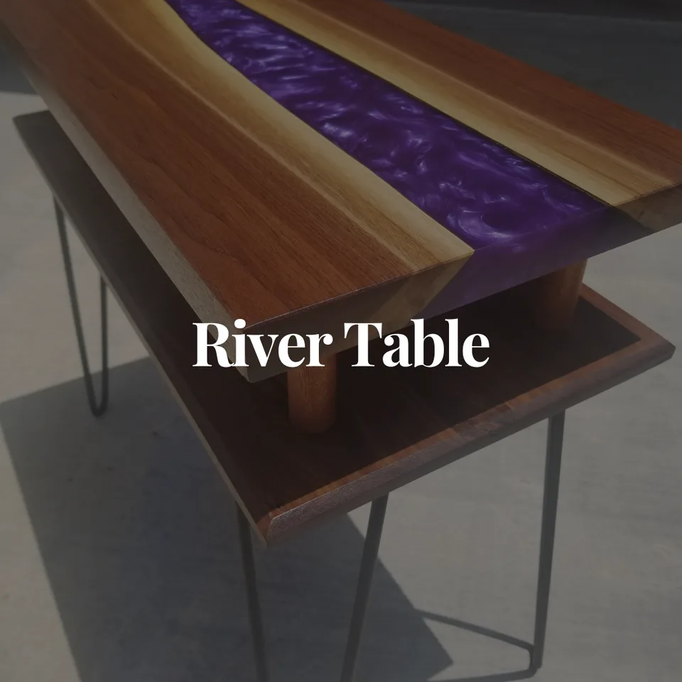 Striking river table featuring wood slabs with vibrant purple resin inlay on modern metal hairpin legs in showroom setting.